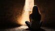 © pornchan - Girl sitting in a darkened room, light streaming in through a narrow window