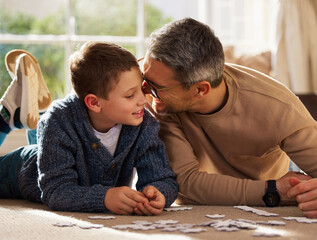 Canvas Print - Father, son and play with puzzle at house for problem solving, learning and connect pieces of education. Smile, family and jigsaw fun with creative development, bonding together and childhood support