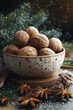 © stanhert - A bowl of walnuts on a wooden table with a Christmas tree in the background