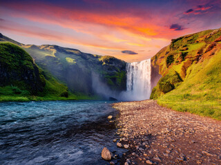 waterfall and dramatic sunset sky