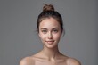 © Ananto - Closeup studio shot of a beautiful young woman with freckles skin posing against a grey background
