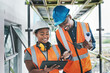 © peopleimages.com - Construction site, black people and smile with tablet for inspection, building development or research. Teamwork, man or woman for engineering with digital, maintenance or architecture with blueprint