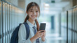 © ABX - Japanese Teenager Smiling at Smartphone in Hand