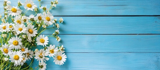 Poster - A lovely bouquet of daisy flowers on a blue wooden background with copy space
