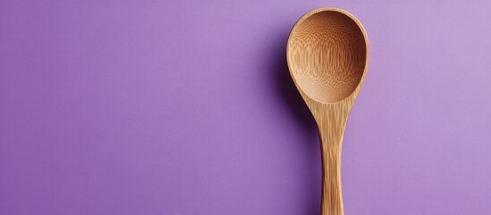 Fototapete - Wooden kitchen utensils that convey a classic and minimalist feel Concept of food and drink Food photography Wooden spoon on the surface Purple backdrop. with copy space image