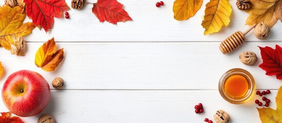 Poster - Bright autumn leaves walnuts honey apples and berries arranged on a white wooden table This creates a festive fall decoration for Thanksgiving or Halloween. with copy space image