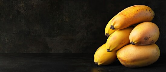 Aufkleber - Pile of mangos with bananas isolated on a black background copyspace