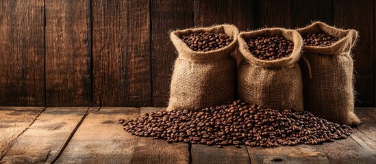 Fototapete - Bags filled with coffee beans on a wooden surface. with copy space image. Place for adding text or design