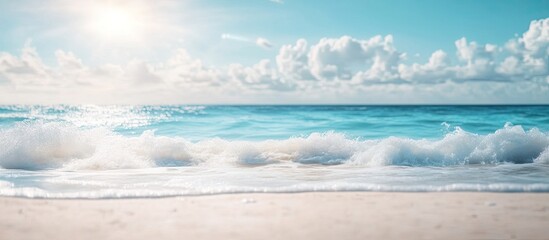 Wall Mural - Blurred tropical beach with bokeh sunlight and waves against a blue sky and white clouds creates an abstract background Copy space for outdoor summer vacations and travel adventures Vintage tone fil