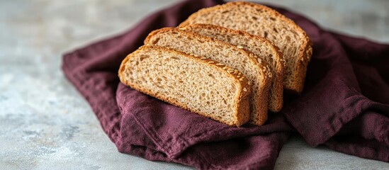 Poster - slices of cereal based yeast free bread wrapped in a burgundy cotton napkin selective focus. with copy space image. Place for adding text or design