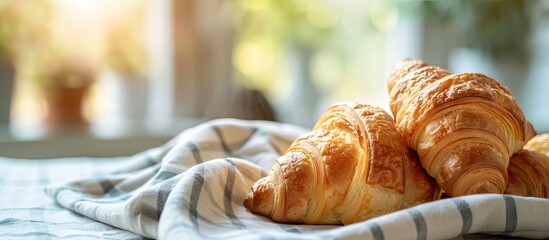 Poster - Homemade French croissants just out of the oven on a tablecloth Selective focus Blank area for text. with copy space image. Place for adding text or design