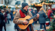 © sabyna75 - Festive street musician performing at winter market for holiday cheer