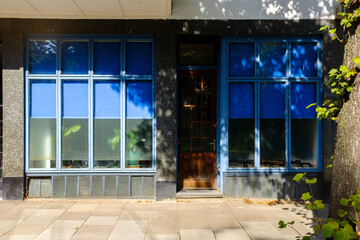 closed second hand shop in the urban city near side walk. locked store front.