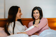 © Guillem de Balanzó - Two Friends Chatting and Smiling in Bed
