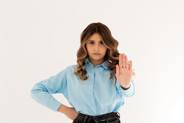 Portrait of young woman making stop sign in front of the camera.