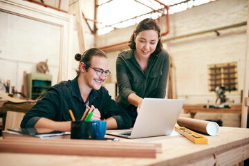 Poster - Carpentry, teamwork and people on laptop in workshop for timber, lumber and furniture manufacturing. Construction business, woodworking and man and woman on tech for online order, meeting or planning