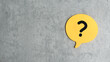 © MohamadFaizal - Q&A or questions and answers concept. yellow bubble speech written with question symbol over a gray background with copy space.