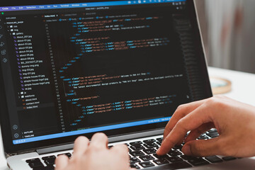 Digital technology, software development concept. Developing programmer, software developer coding computer code on laptop computer. Perfect for coding, IT solutions, applications, coding javascript