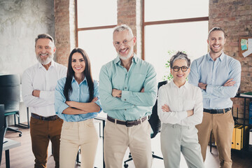 Photo of teamwork people working together confident posing crossed hands comfortable modern office loft room interior indoors workspace