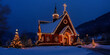 © Andres Mejia - Christmas lights illuminating church at twilight in snowy landscape