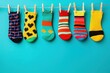© WinThing - Colorful socks hanging on a clothesline against a blue background.