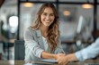 © k - Smiling businesswoman shaking hands with client at office desk, professional meeting, corporate agreement