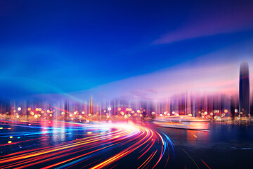 Poster - A city skyline at night with blurred light trails streaking through the foreground.
