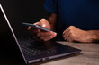© Artvibe - shirt works in a modern office. the man is typing on a laptop