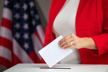 Wall Mural - Voting women near ballot box on table against flag of USA