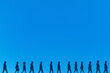 © VazzBee - Lineup of Silhouettes on Blue Background