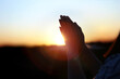 © artpluskr - New Year sunrise rising sun background and shining light through praying christian hands, future hope and wish concept