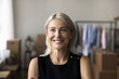 © fizkes - Headshot portrait of beautiful mid aged woman posing indoors with healthy toothy smile. Happy elderly female renter tenant buyer of new apartment flat office space looking at camera at relocation day