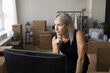 © fizkes - Busy old woman webshop owner ponder on optimal logistics of internet orders transportation distracted from pc screen. Pensive dropshipper solve problem of directing goods delivery from seller to buyer