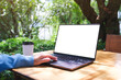 © Farknot Architect - Mockup image of a woman using and touching on laptop computer touchpad with blank white desktop screen in the outdoors