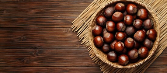 Canvas Print - A bamboo bowl filled with fresh sweet chestnuts Top view copy space