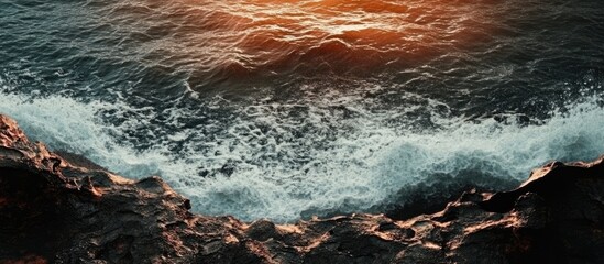 Wall Mural - stunning view of ocean water and dark lava sand. with copy space image. Place for adding text or design