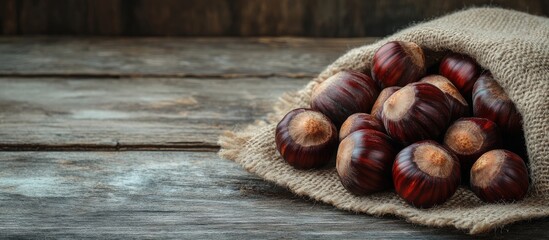 Poster - Fresh chestnuts on a vintage wooden table with a sack cloth napkin. with copy space image. Place for adding text or design