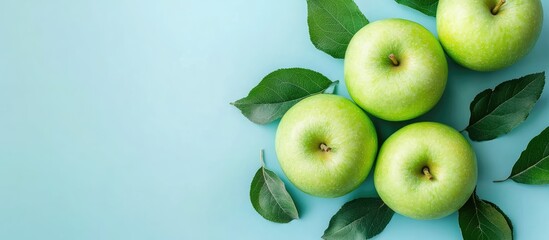 Poster - Fresh juice made from green apples on a blue background top view images featuring copy space for text