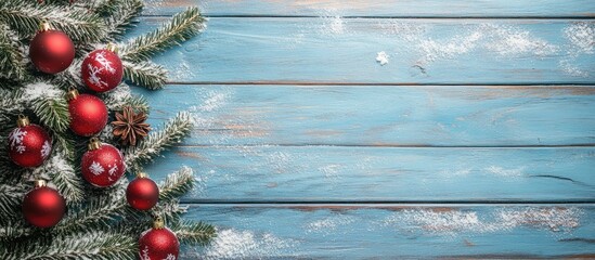 Poster - Decorative Christmas tree and baubles on a blue wooden background with copyspace