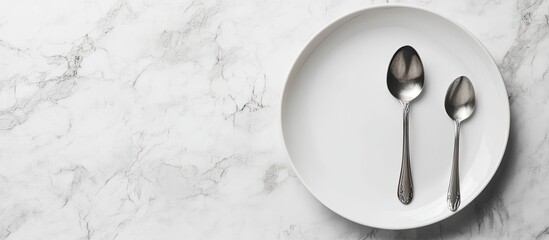 Fototapete - Image of an empty white plate with a spoon and fork set against a white marble background Selective focus with a blurred background. with copy space image. Place for adding text or design