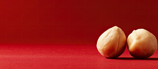 Poster - Close up of a macadamia nut on a red background. with copy space image. Place for adding text or design