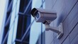 © Ruby Stock - A close-up of a sleek security camera installed on a building, focusing on its features and design