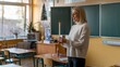 © bteeranan - Teacher Holding Christmas Candle in Classroom