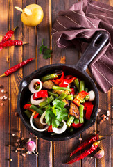 Poster - vegetable stew in pan on wooden table