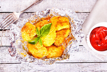 Canvas Print - Homemade golden chicken Nuggets, on foil with Ketchup sauce