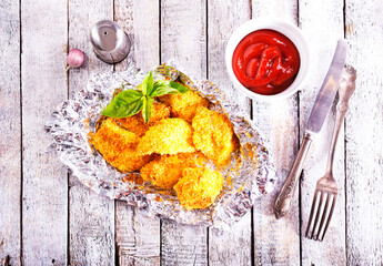 Canvas Print - Homemade golden chicken Nuggets, on foil with Ketchup sauce