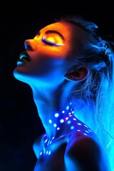 Close-up of a woman with vibrant neon body art under dramatic lighting.