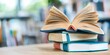 © BOJOShop - Open Book Stack on Wooden Table in Library Setting