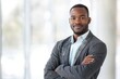 © Odin AI - A young, confident professional man stands in an office, showcasing ambition, success, and modern style, embodying a confident and capable business demeanor.