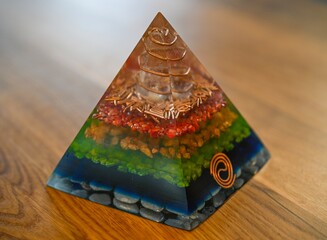 High resolution image of a single isolated beautiful one of a kind hand made Orgone pyramid generator containing crystals